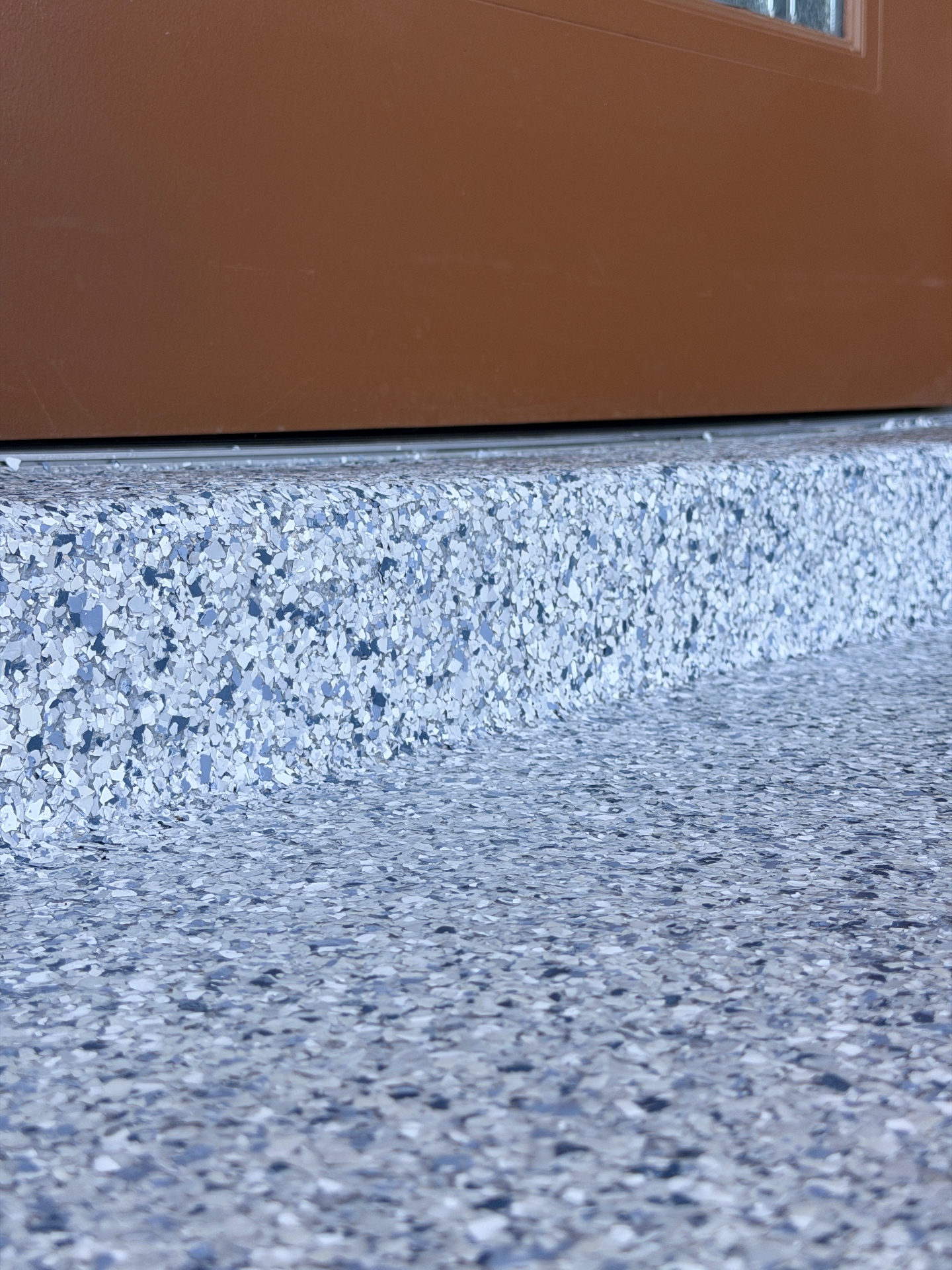 Flake epoxy floor coating detail with cove base