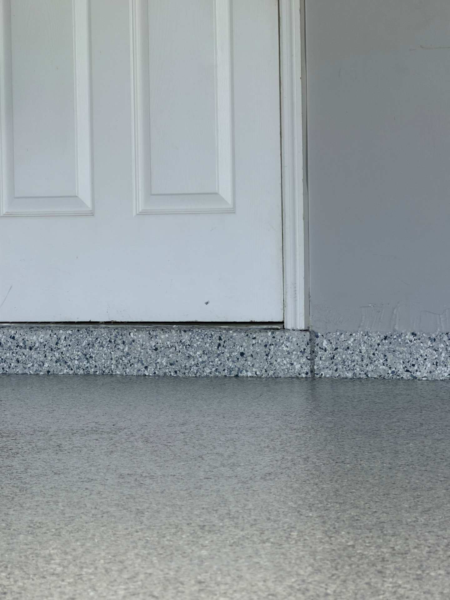 Epoxy cove base detail at door threshold