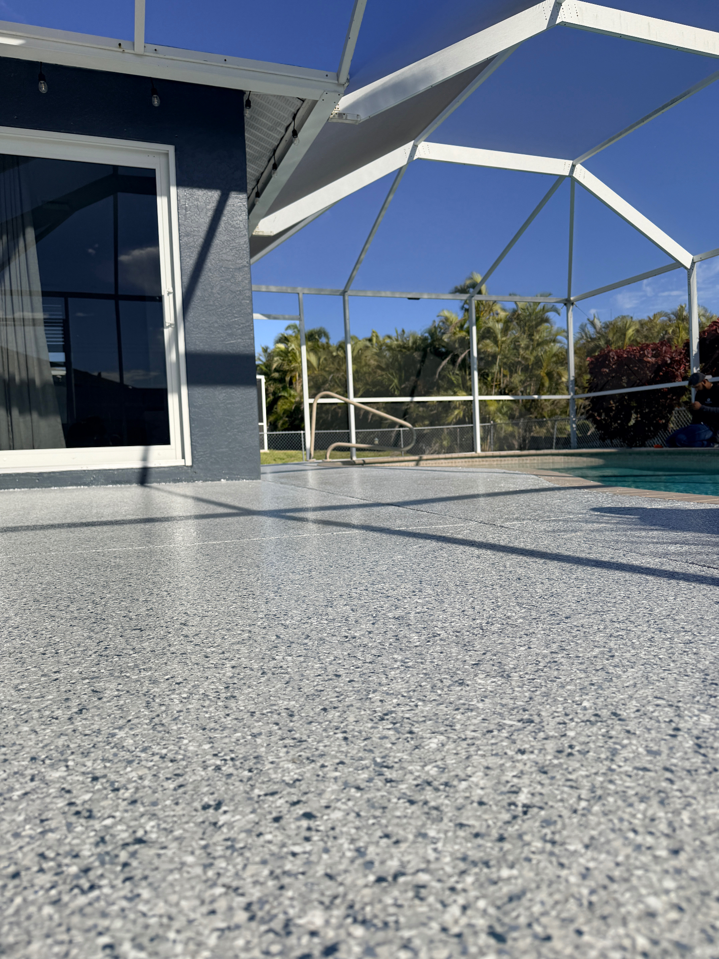 Epoxy coated pool deck with screen enclosure