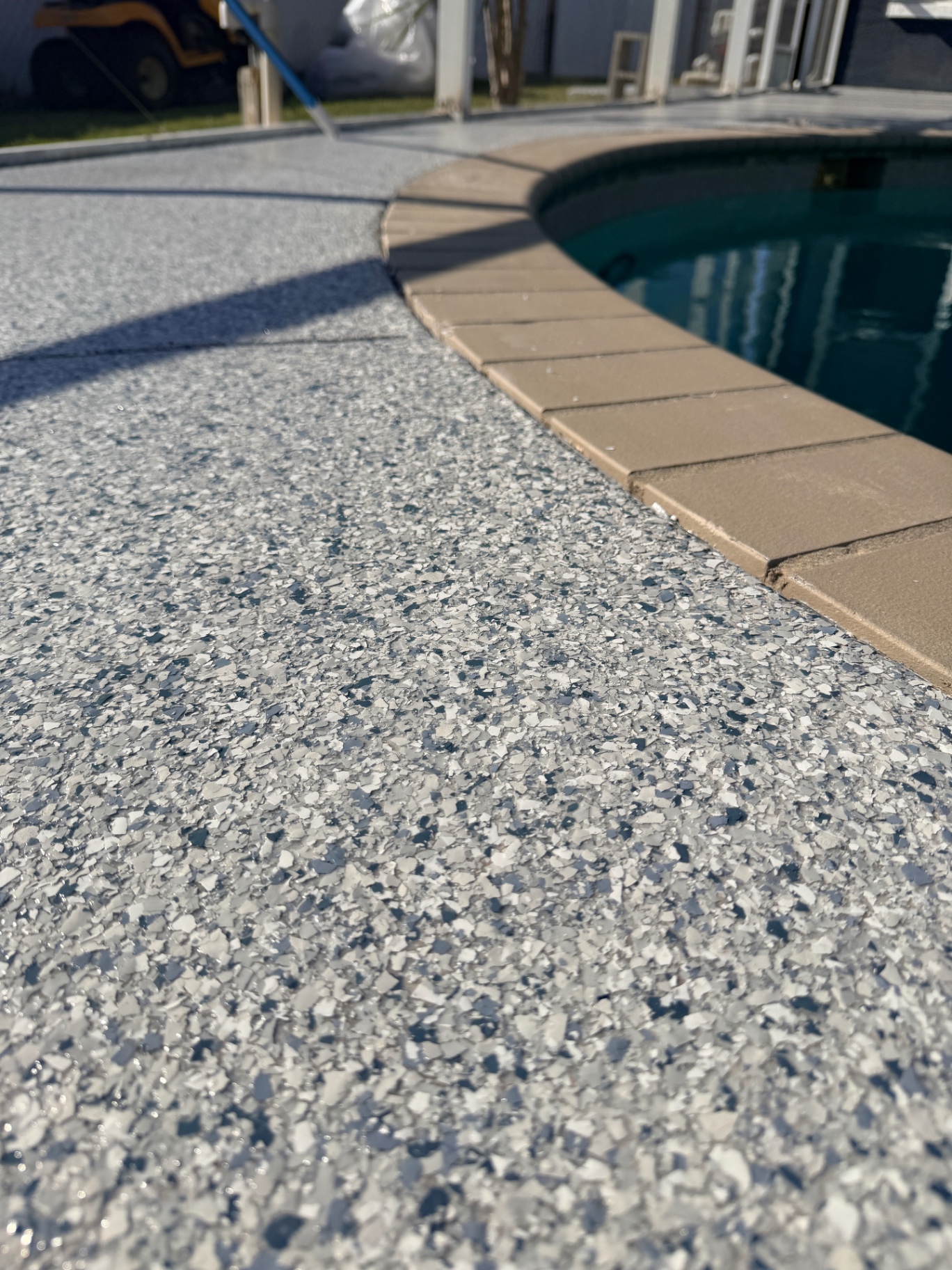 Flake epoxy pool deck detail near pool edge
