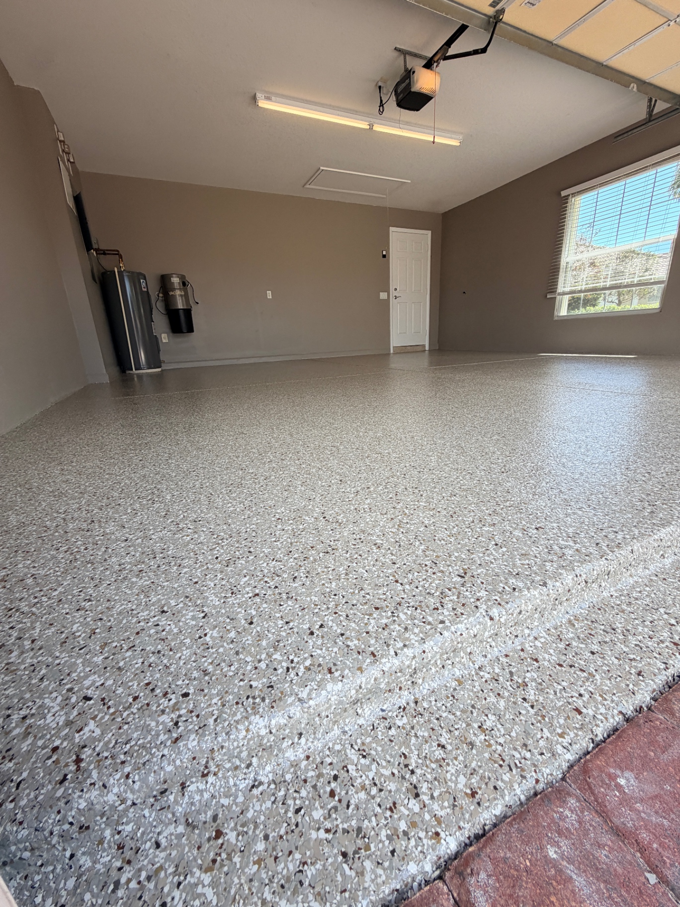 Garage floor coating with decorative flake and cove base